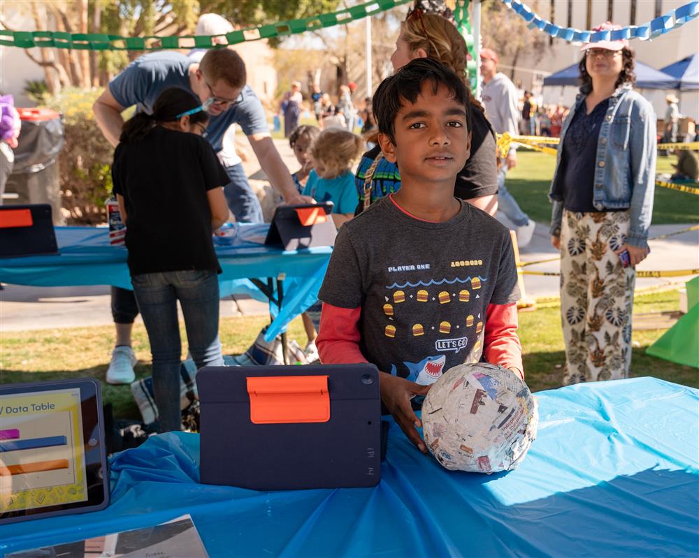 An image of a Weinberg Gifted Academy student showcasing his science project.
